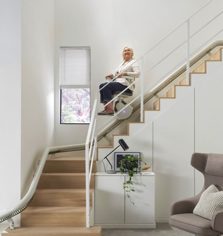 flow x curve stair lift with woman midway